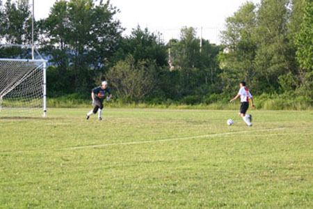 Sporting Rangers #11 gets a breakaway and faces the Bridgewater Old Timer keeper in recent Masters Division Play.