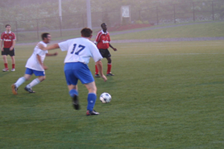 A Dartmouth United Player prepares to pass to a team mate, during a offense chance versus Dunbrack.