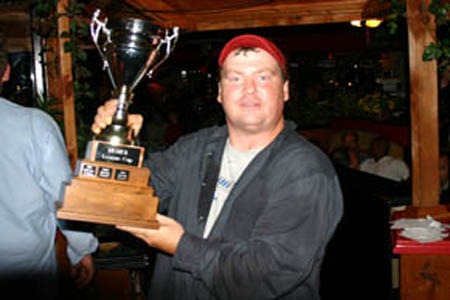 Team Manager Kevin Boutlier accepts the league challenge cup at the recent award banquet.